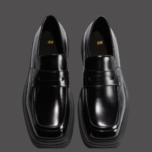 Shiny black leather penny loafers.